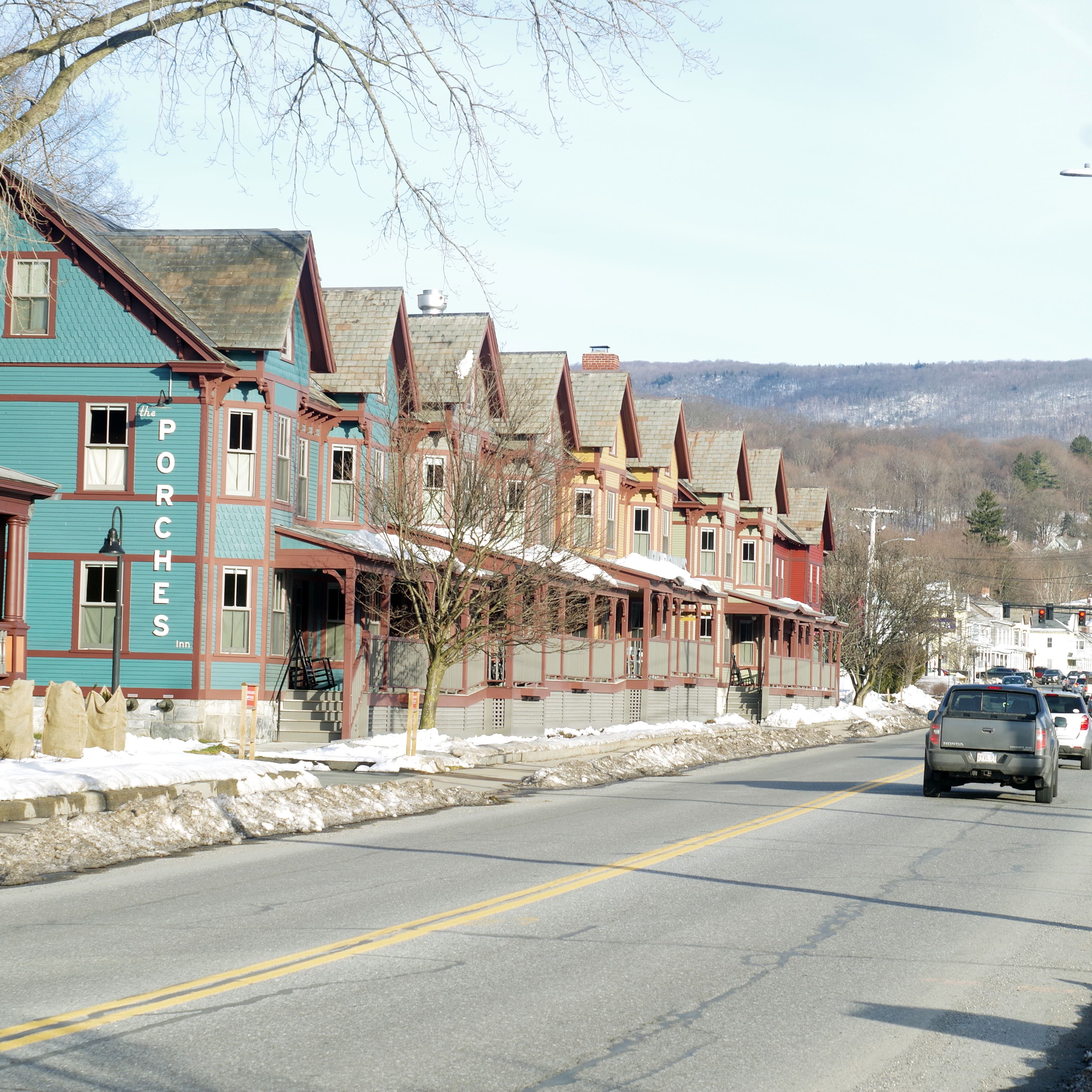 wooden rowhouses, painted blue, green, yellow, and red