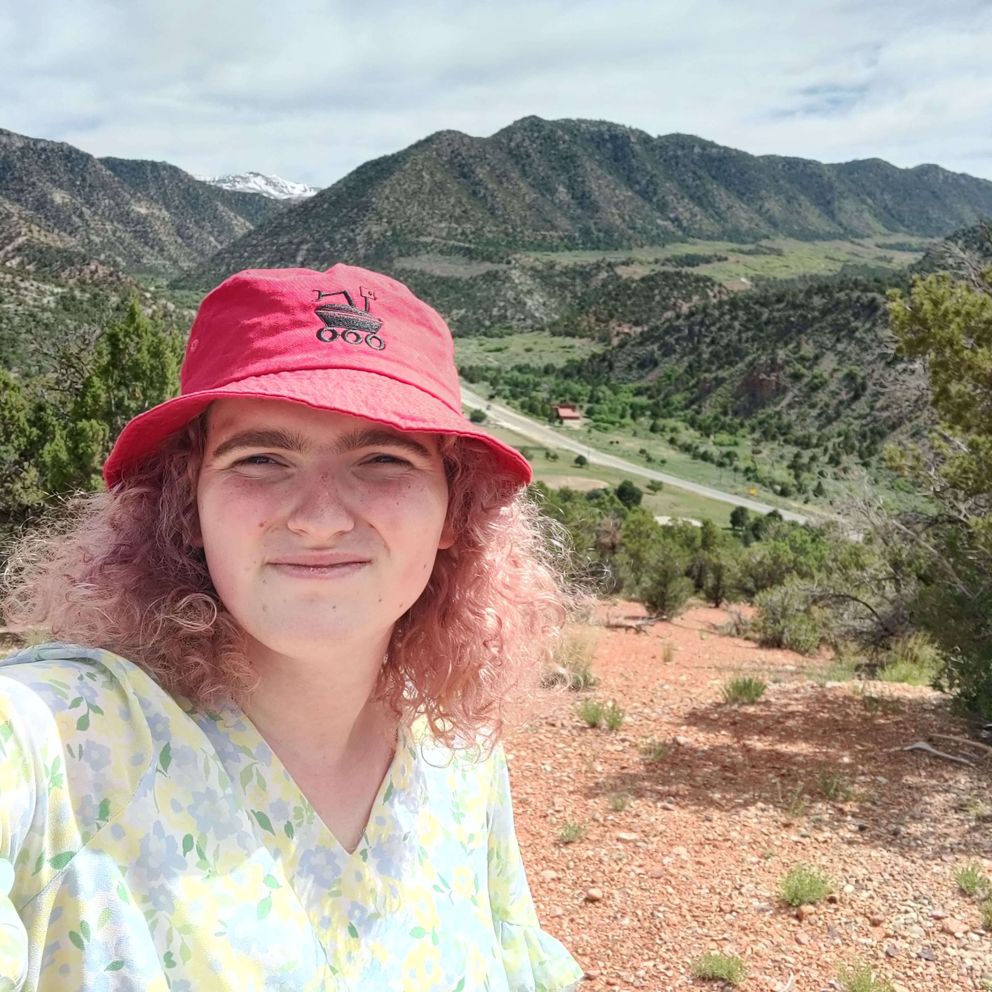 a selfie from on top of a hill