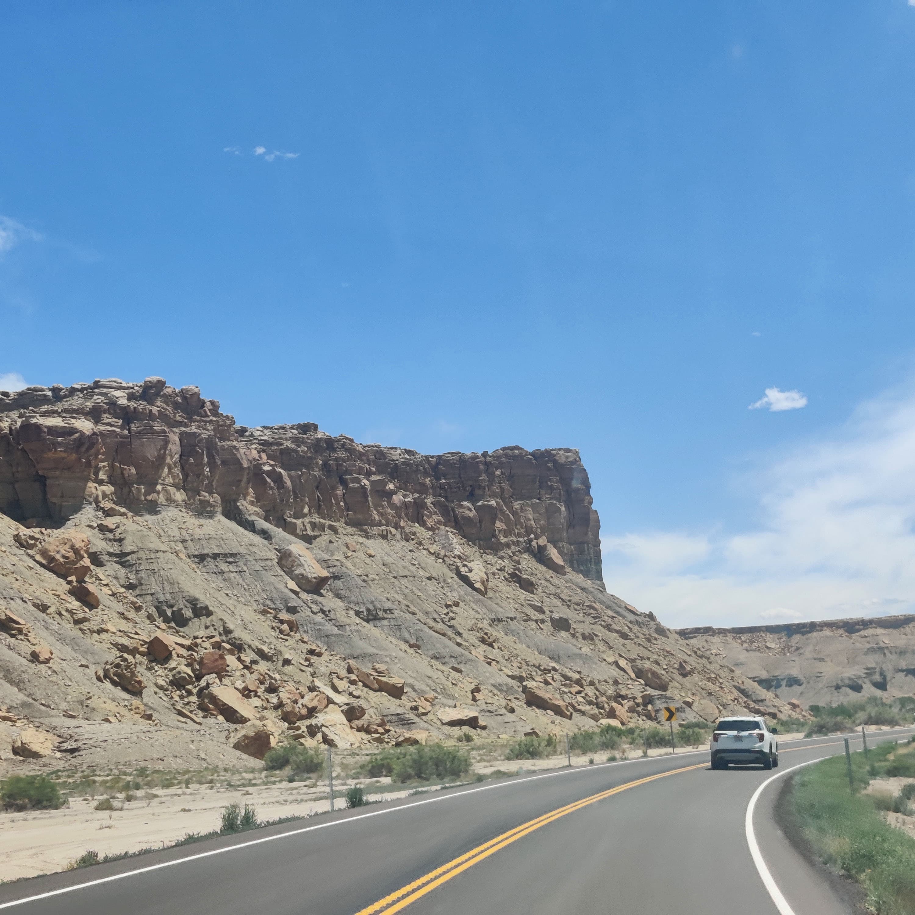 a gray mesa next to a road