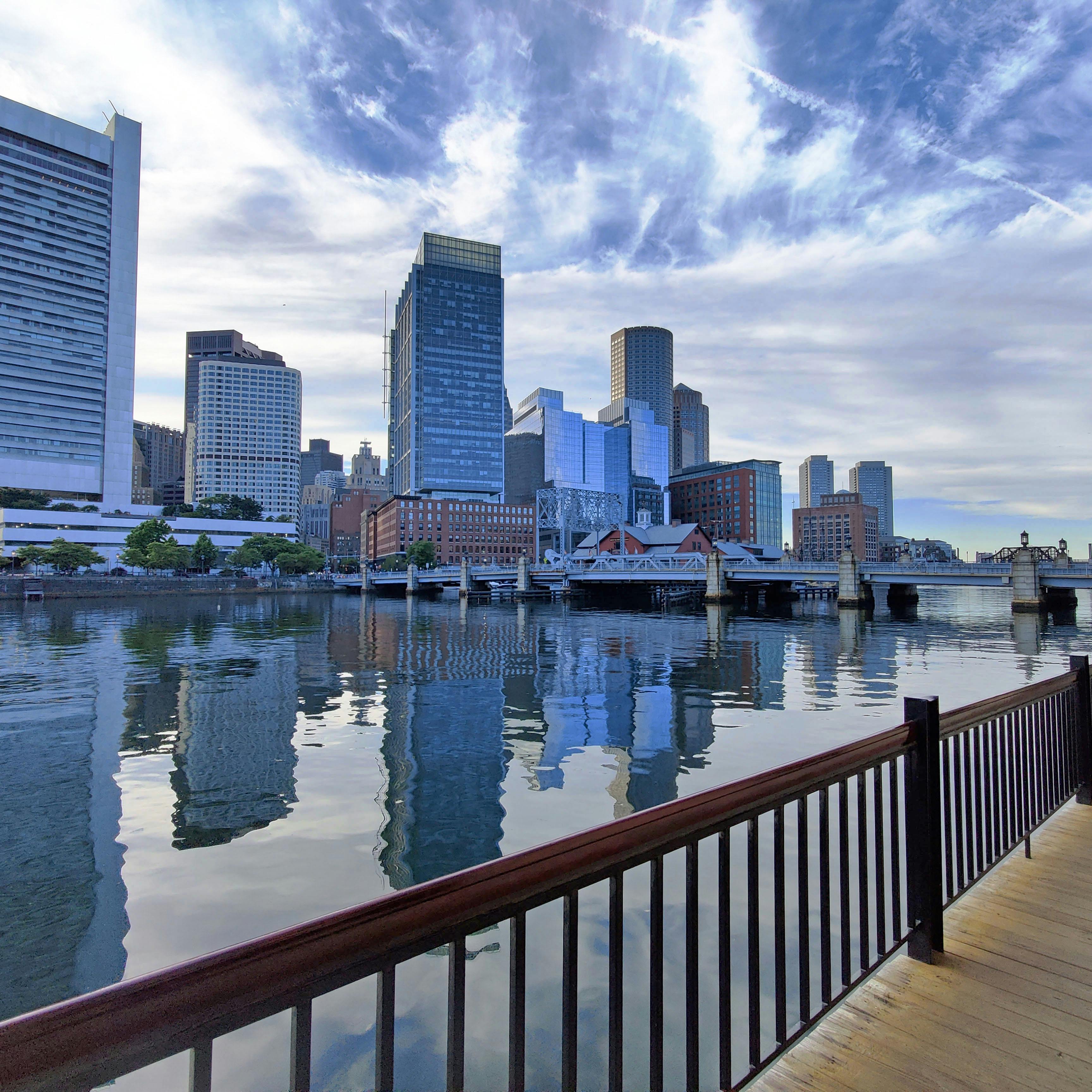 the boston business district skyline, viewed from the harborwalk in seaport