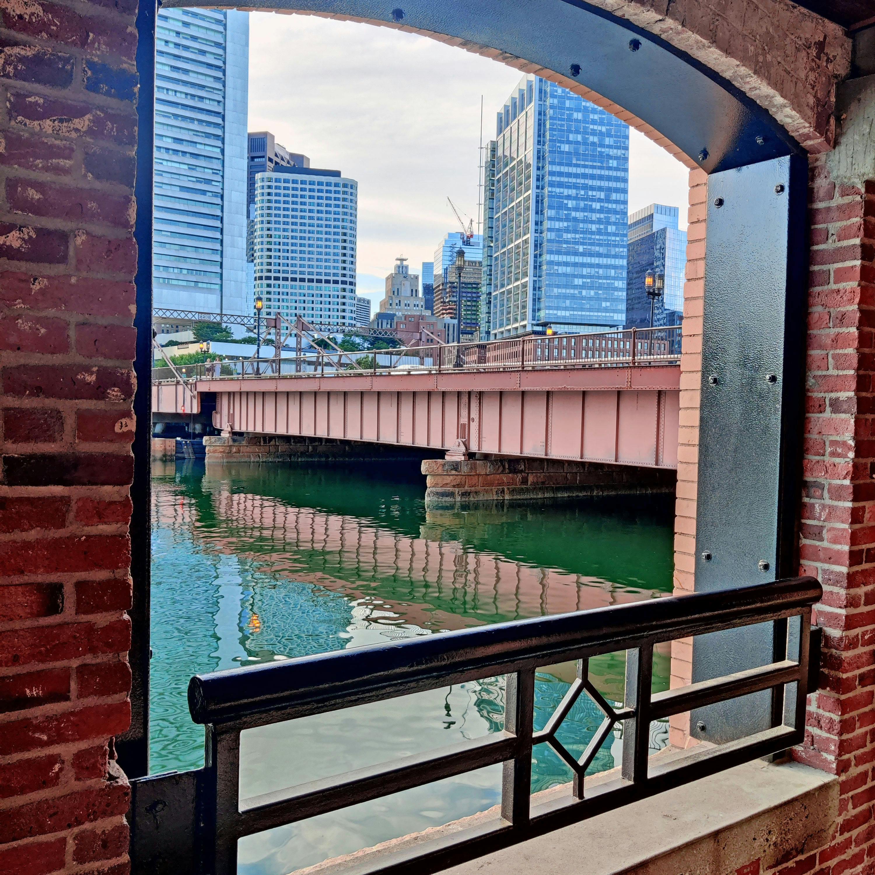 looking through a brick window towards the canal on the harborwalk