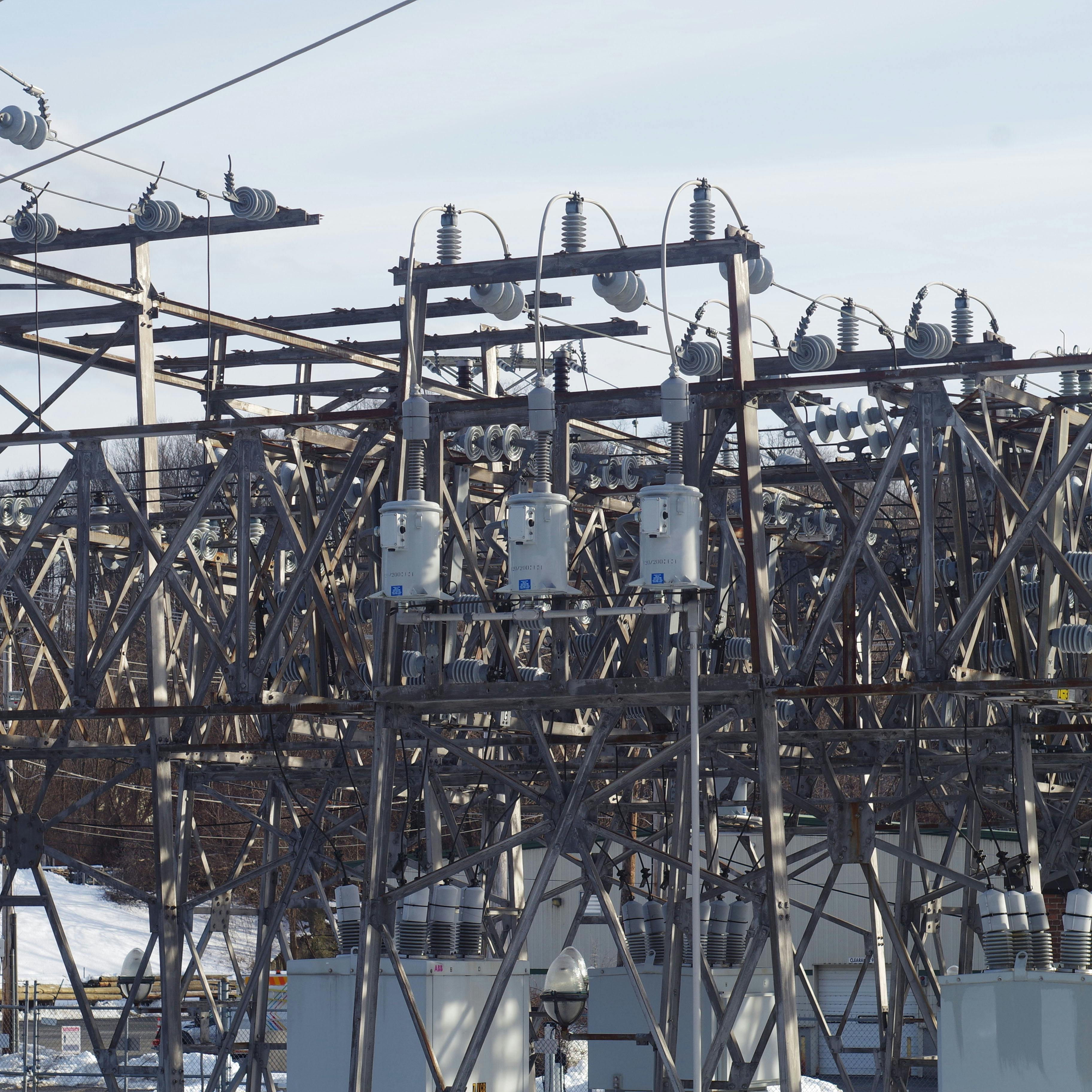 a power substation, showing a complex system of metal beams and large transformers