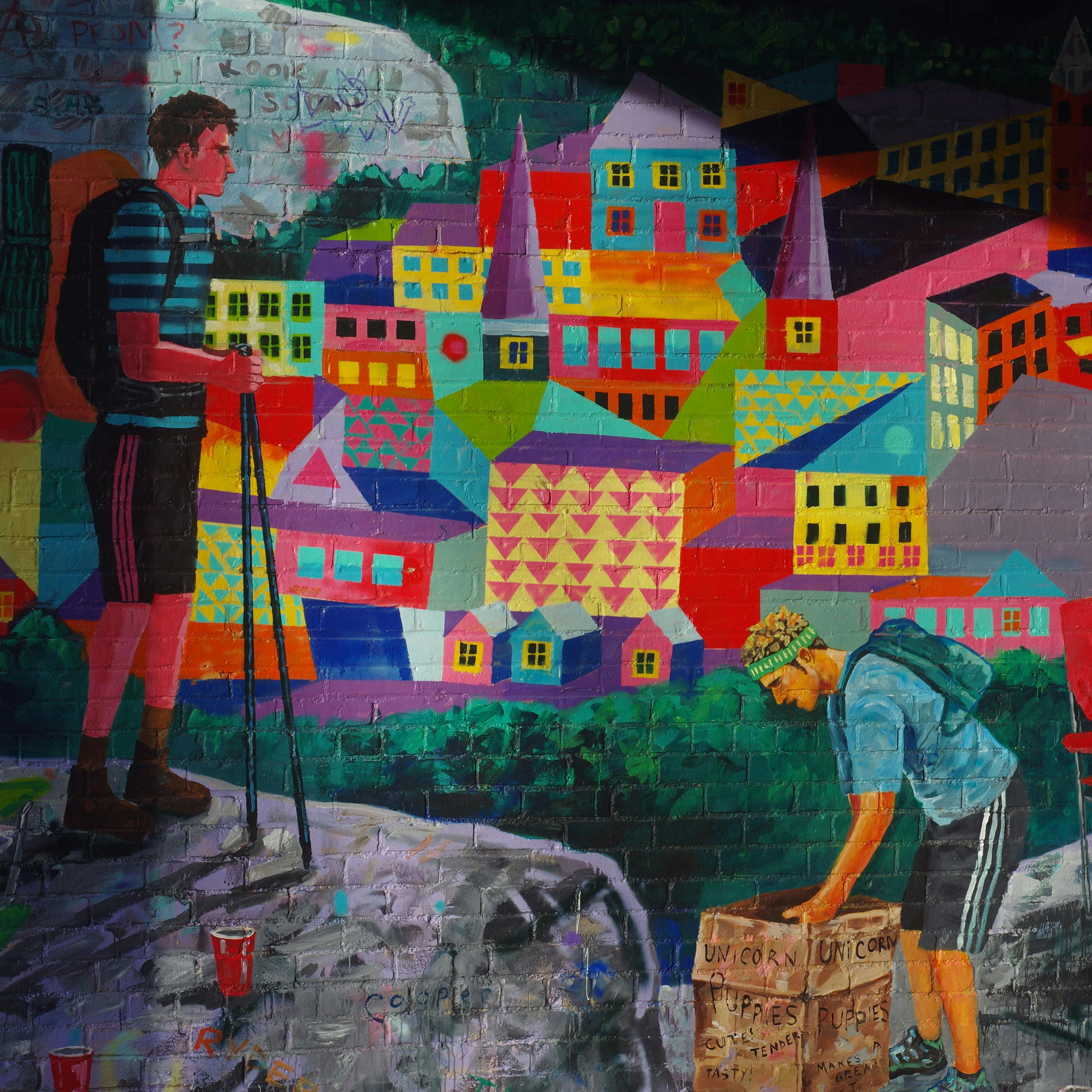 a mural depicting a colorful town and a hiker at the top of a mountain